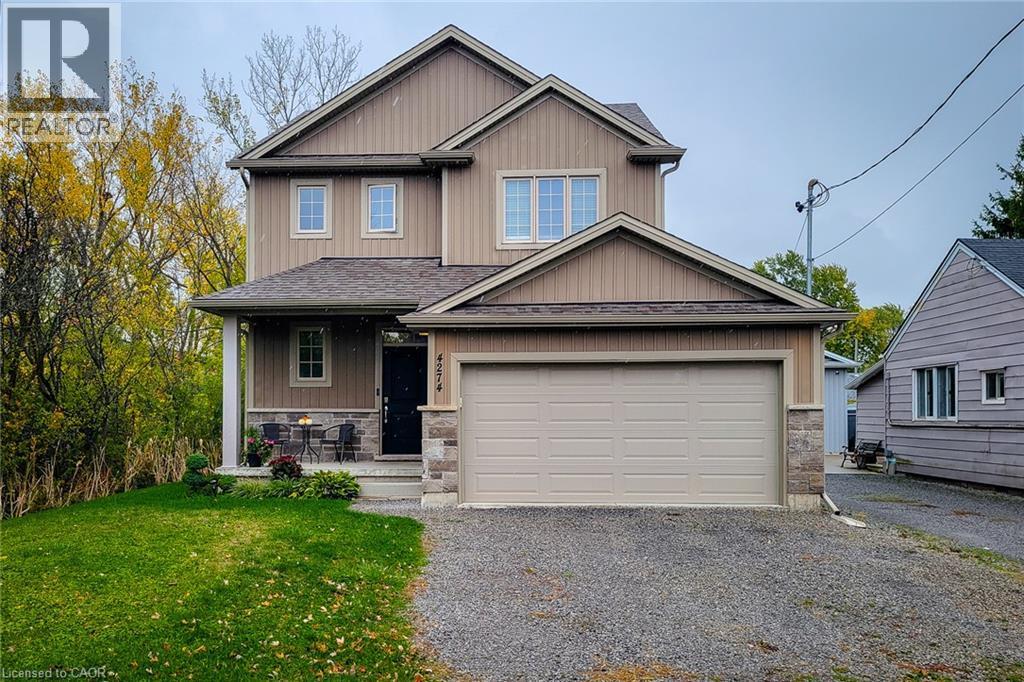 Two-story residence featuring vertical siding and stone veneer accents - 4274 Sixth Avenue, Niagara Falls, ON