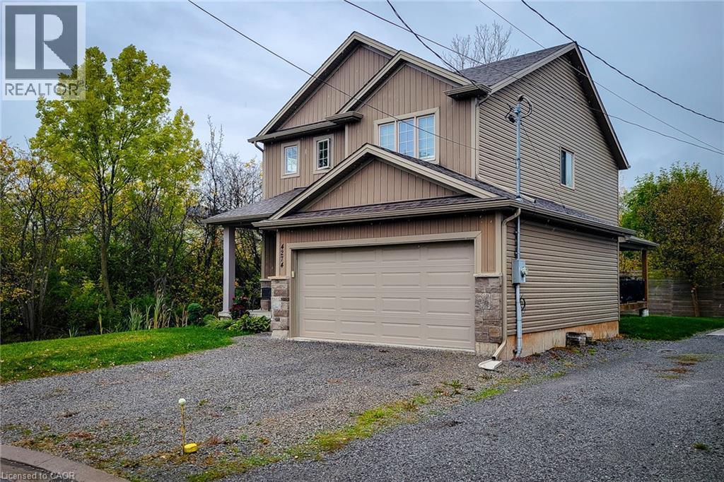 Two-story residence featuring siding and stone exterior accents - 4274 Sixth Avenue, Niagara Falls, ON