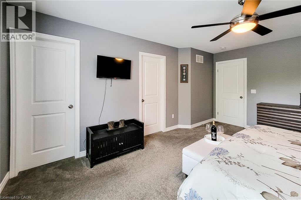 Recessed lighting, ceiling fan with integrated lighting, wall-mounted television, and carpeted flooring - 4274 Sixth Avenue, Niagara Falls, ON