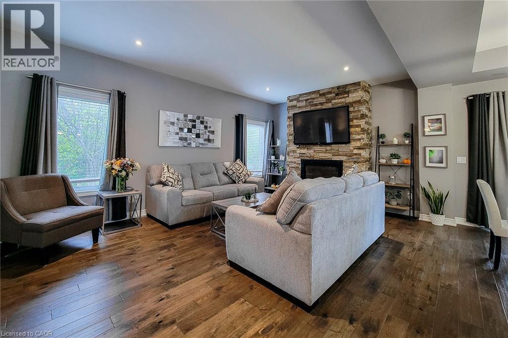 Wood-finish flooring throughout, recessed lighting, and a stone-clad fireplace - 4274 Sixth Avenue, Niagara Falls, ON