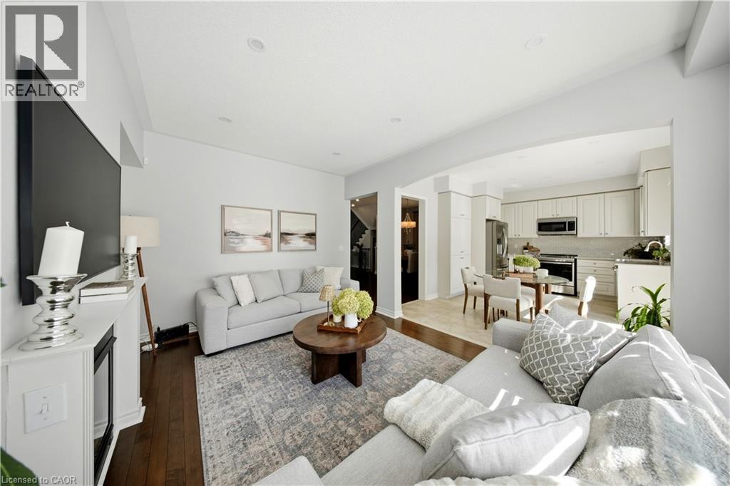 Hardwood-finish flooring, recessed lighting, and a white fireplace mantel - 3352 Hiscott Avenue, Burlington, ON