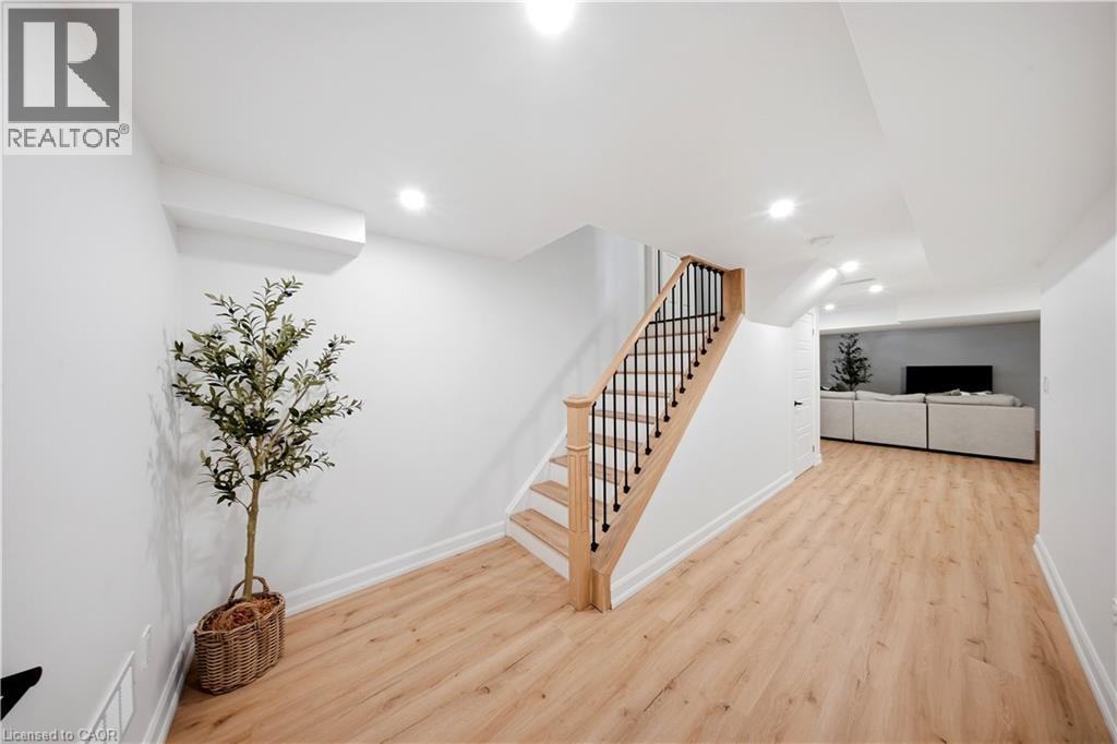 Recessed lighting illuminates the wood-finish flooring - 3352 Hiscott Avenue, Burlington, ON