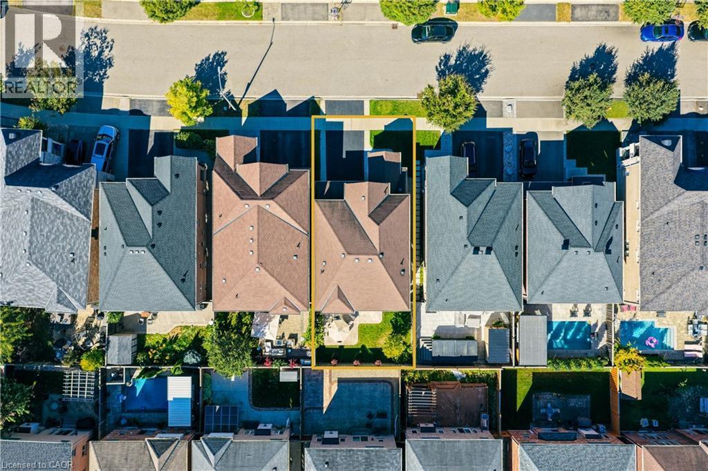 Aerial perspective showcasing a single-family residence with a multi-gabled roofline and an attached garage - 3352 Hiscott Avenue, Burlington, ON