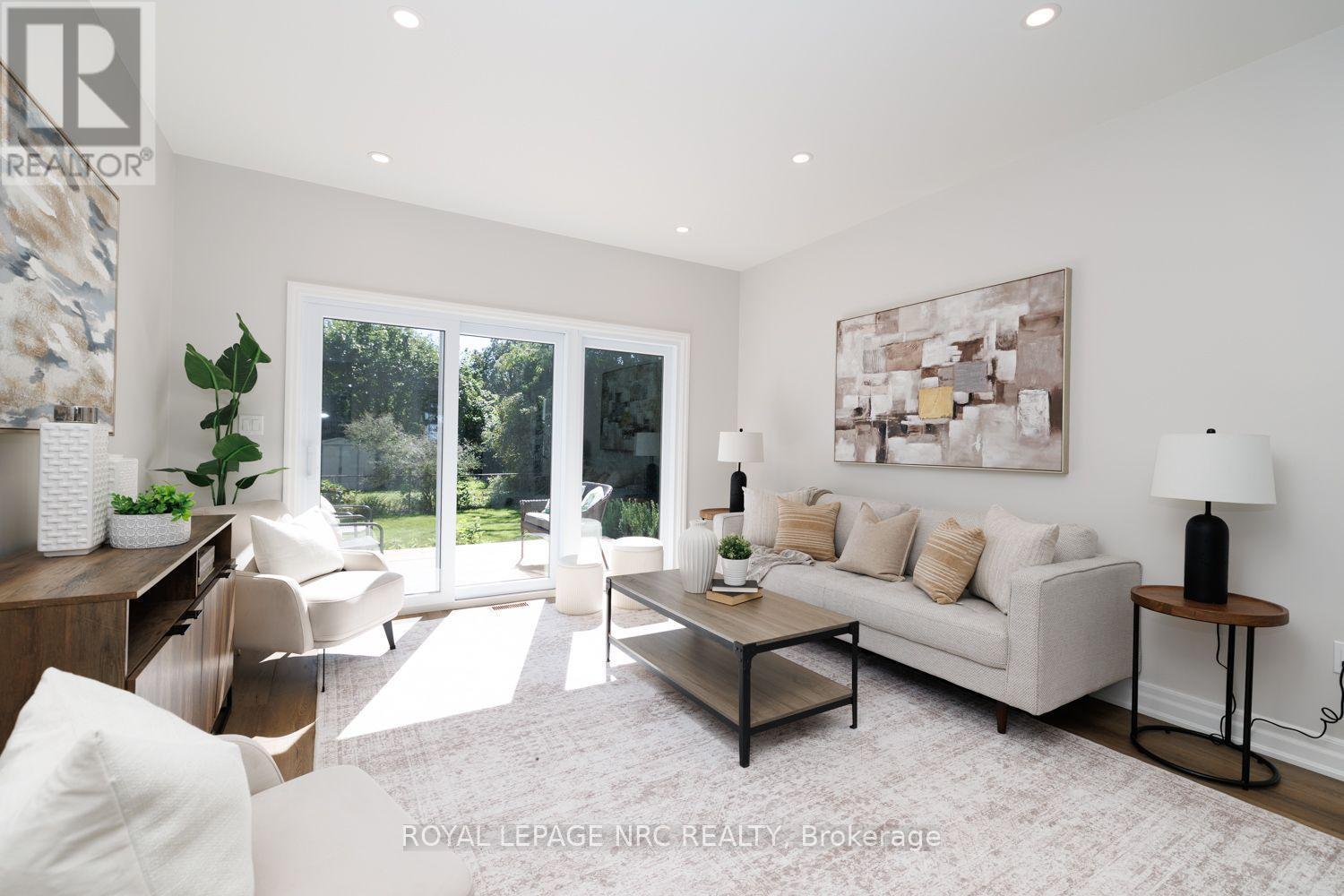 Living room has doors to the backyard. - 3 Peel Street, St. Catharines (Port Dalhousie), ON