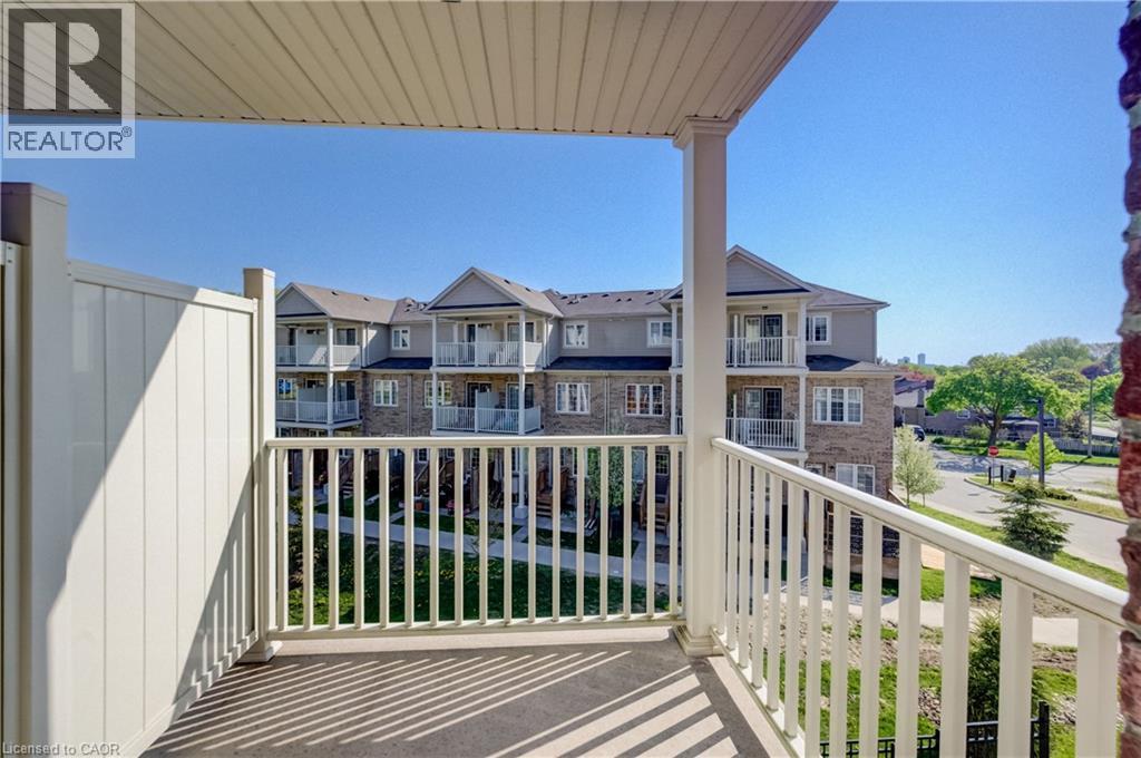 Private balcony with white railing, featuring a solid privacy wall and a paneled ceiling - 403 Westwood Drive Unit# 59, Kitchener, ON