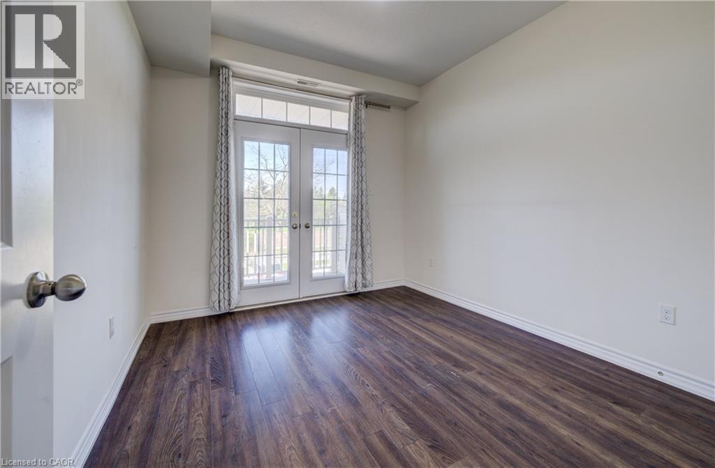 French doors with louvered blinds open to a balcony - 403 Westwood Drive Unit# 59, Kitchener, ON