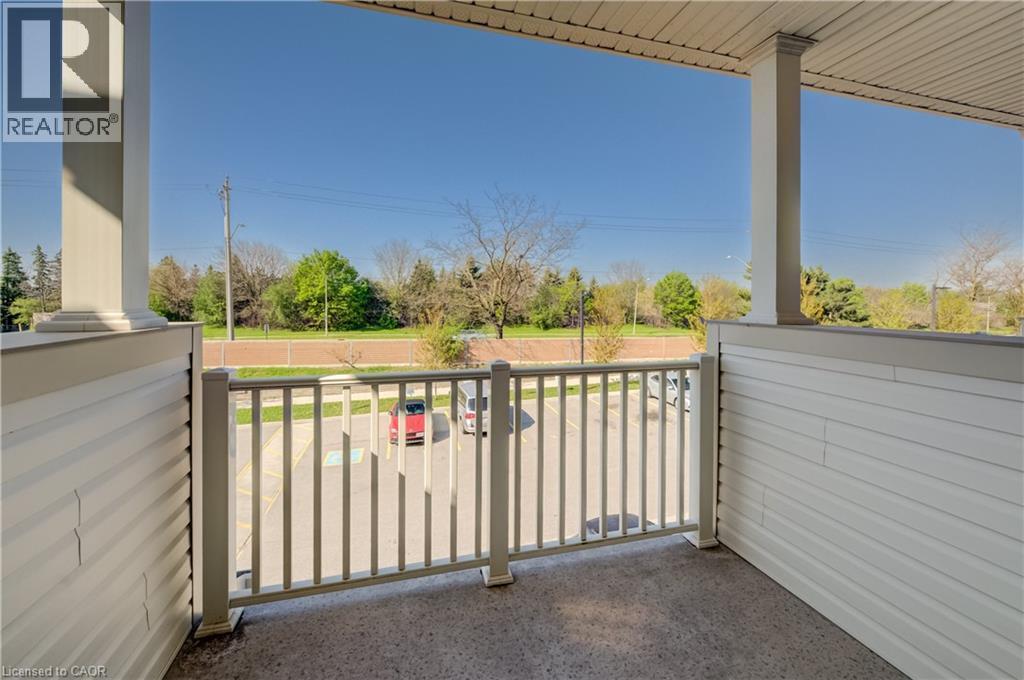 Outdoor balcony featuring a concrete floor, white vinyl siding, and a sturdy railing - 403 Westwood Drive Unit# 59, Kitchener, ON
