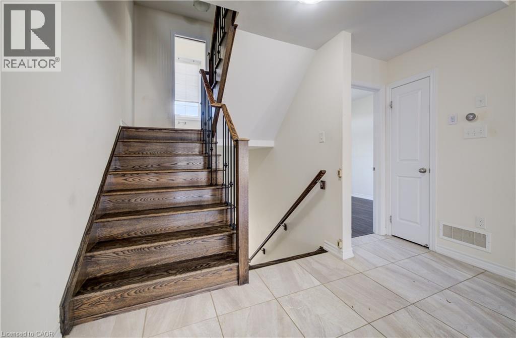 Hardwood staircase with wrought iron spindles and wood handrails - 403 Westwood Drive Unit# 59, Kitchener, ON