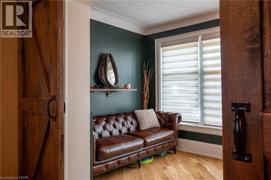 Wood-finish flooring with a barn door entry - 283 Plains Road W, Burlington, ON