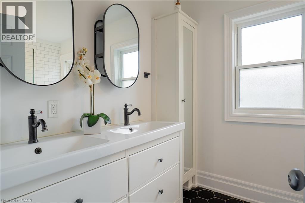 Dual vanity with integrated sinks and matte black fixtures - 283 Plains Road W, Burlington, ON