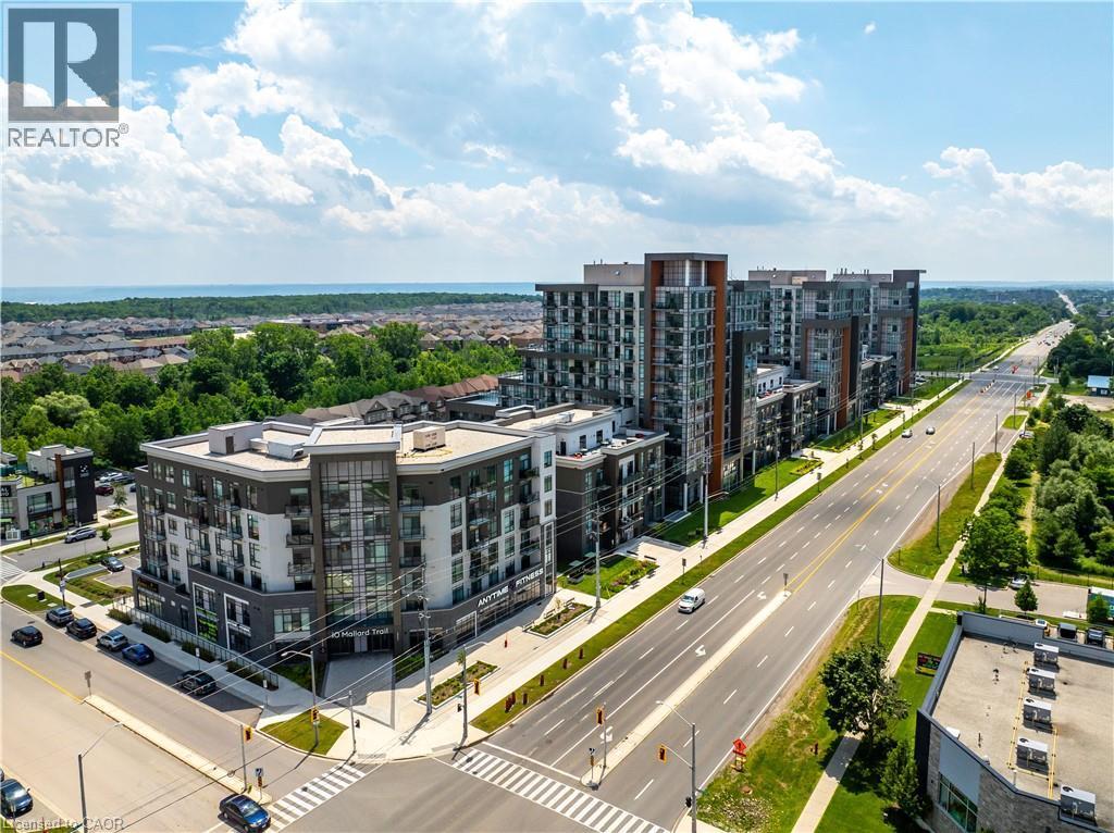 Modern mid-rise building with a mixed-material facade and multiple balconies - 10 Mallard Trail Unit# 237, Waterdown, ON