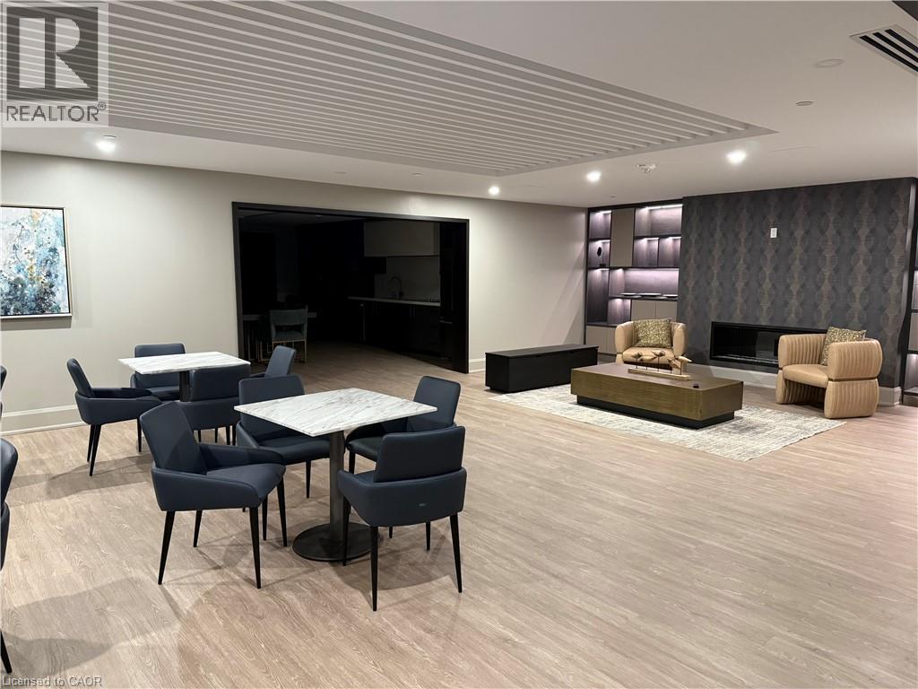 Spacious common area featuring wood-finish flooring, recessed lighting, and a decorative slatted ceiling - 10 Mallard Trail Unit# 237, Waterdown, ON