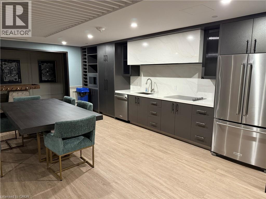 Modern kitchen with stainless steel appliances, white countertops, and full-height backsplash - 10 Mallard Trail Unit# 237, Waterdown, ON
