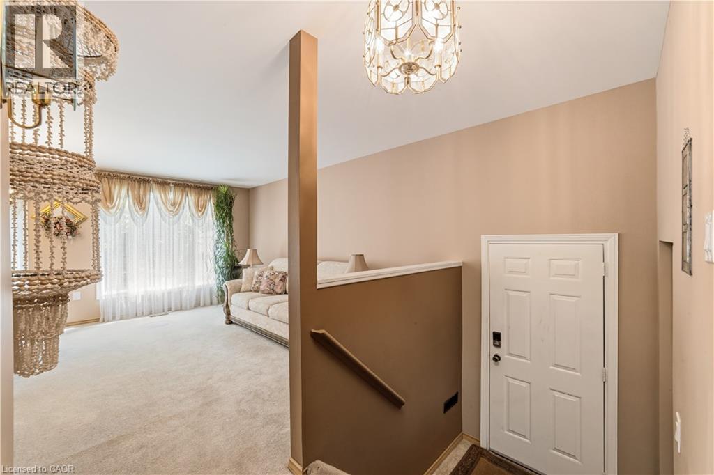 Spacious entrance off the driveway with closet and stairs to main level - 450 Brigadoon Drive, Hamilton, ON