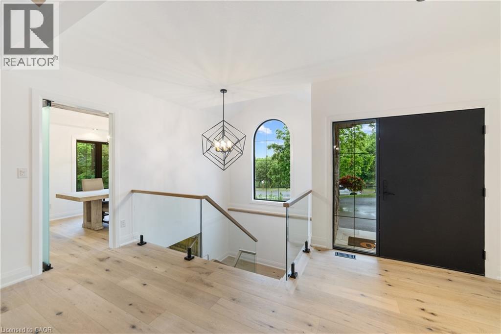 Luxury flooring throughout main level, glass rail with oak open riser staircase, large windows for lots of natural light - 515 Hamilton Drive, Ancaster, ON