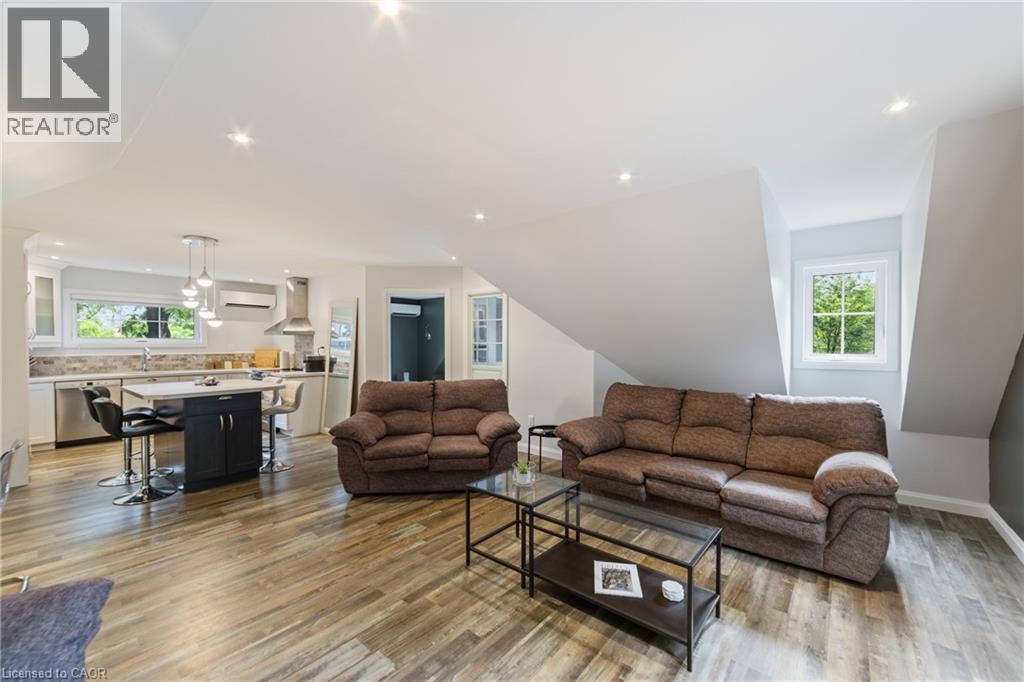 Guest house living area with ample windows, recessed lighting and open concept, sofa set show in photos is included - 515 Hamilton Drive, Ancaster, ON