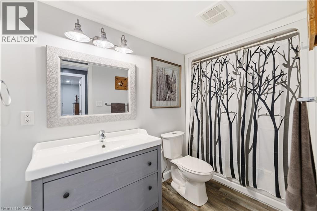 Full bath with laminate flooring, stand alone vanity and tub/shower - 515 Hamilton Drive, Ancaster, ON