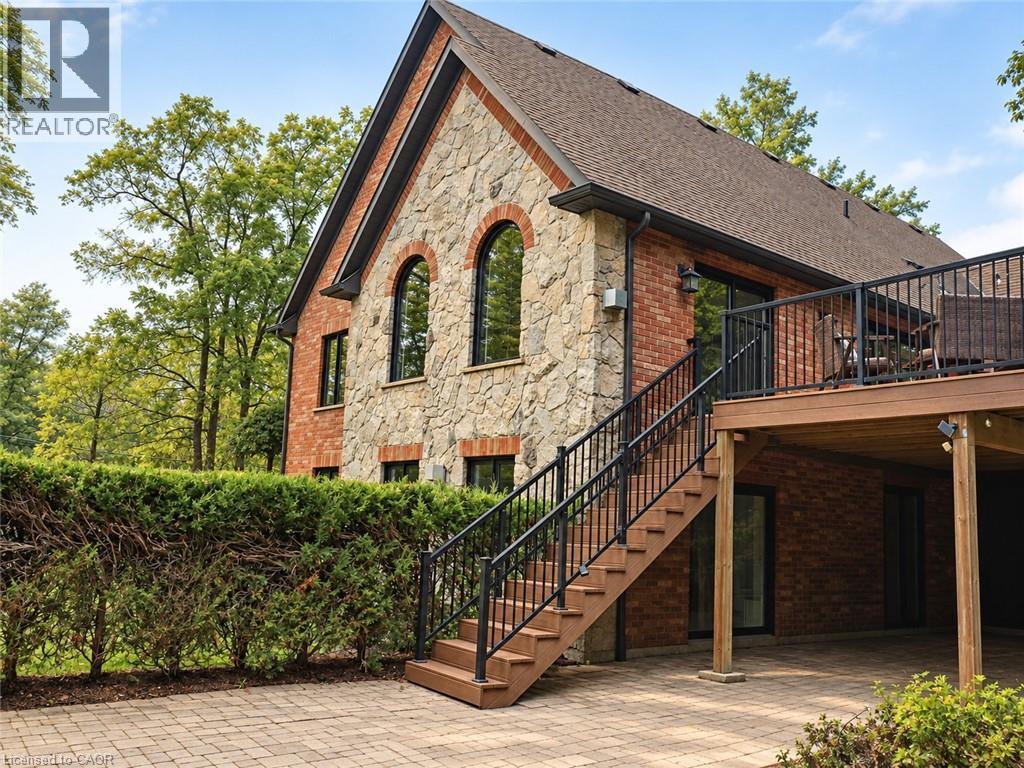 Stone and brick exterior with arched windows - 515 Hamilton Drive, Ancaster, ON