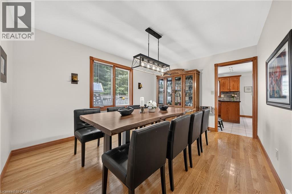 Hardwood flooring, wall-mounted sconce lighting, and a multi-pane window - 52 Archwood Crescent, Cambridge, ON