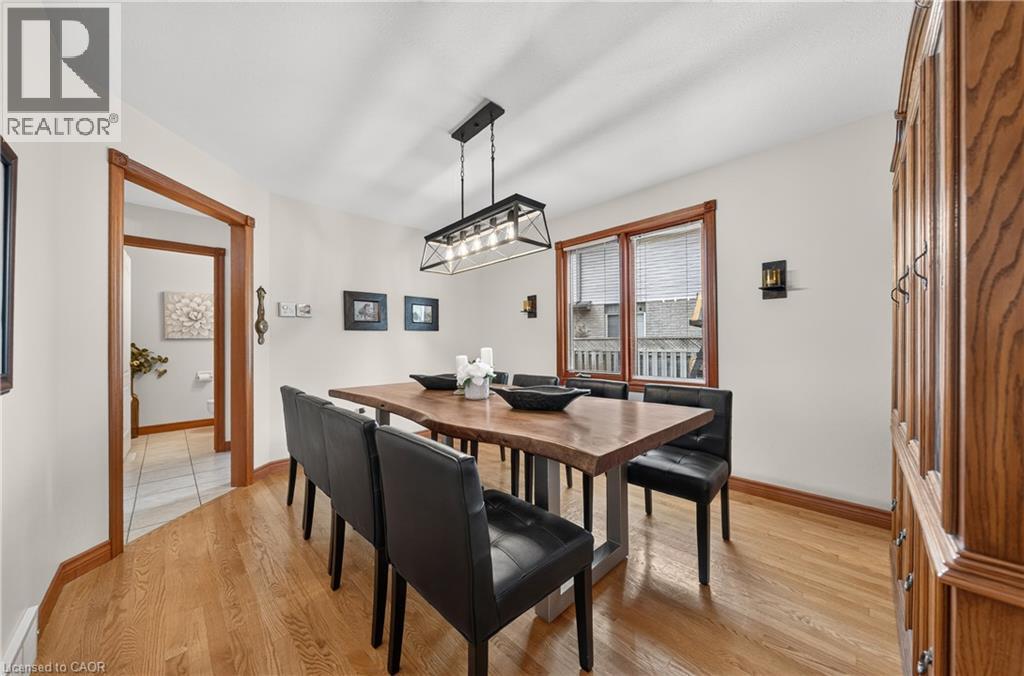 Hardwood flooring, recessed ceiling lighting, wall-mounted sconces, and a multi-pane window - 52 Archwood Crescent, Cambridge, ON