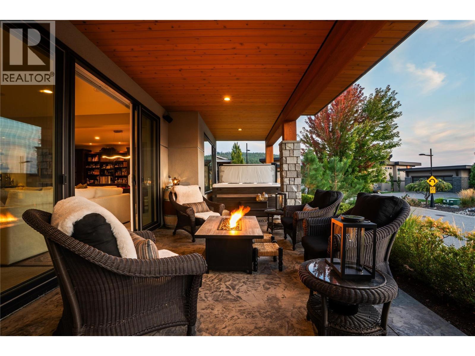 Lower Level patio to Hot Tub at twilight - 1666 Lakestone Drive, Lake Country, BC