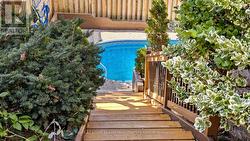 Side Wooden Stairs Leading to A Walk-Out and Pool -