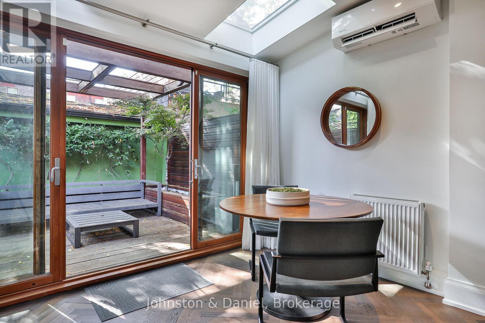 Breakfast area opens to serene garden - 69 Sullivan Street, Toronto, ON