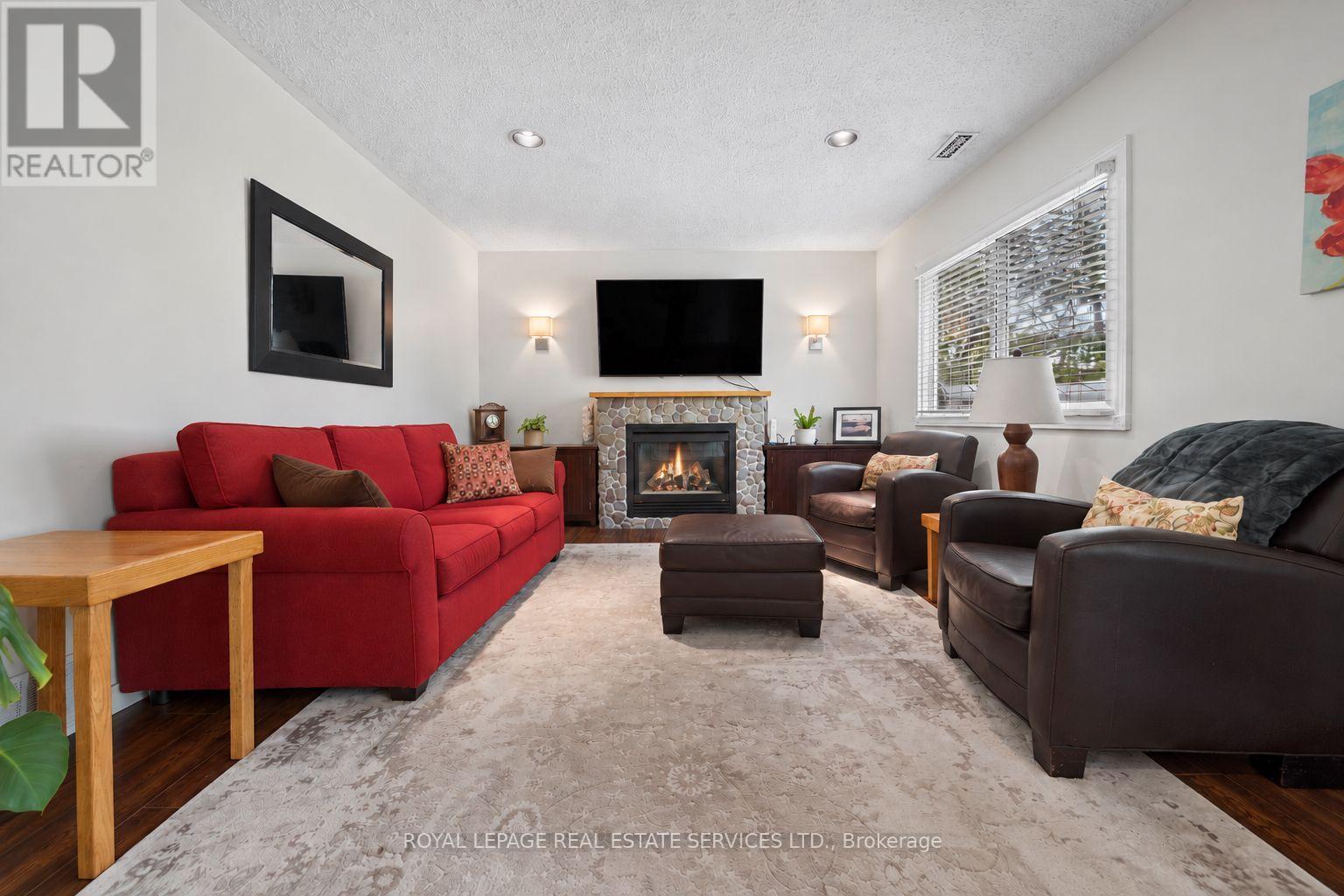 Spacious Living Room Features Stone Gas Fireplace - 46 Germorda Drive, Oakville, ON