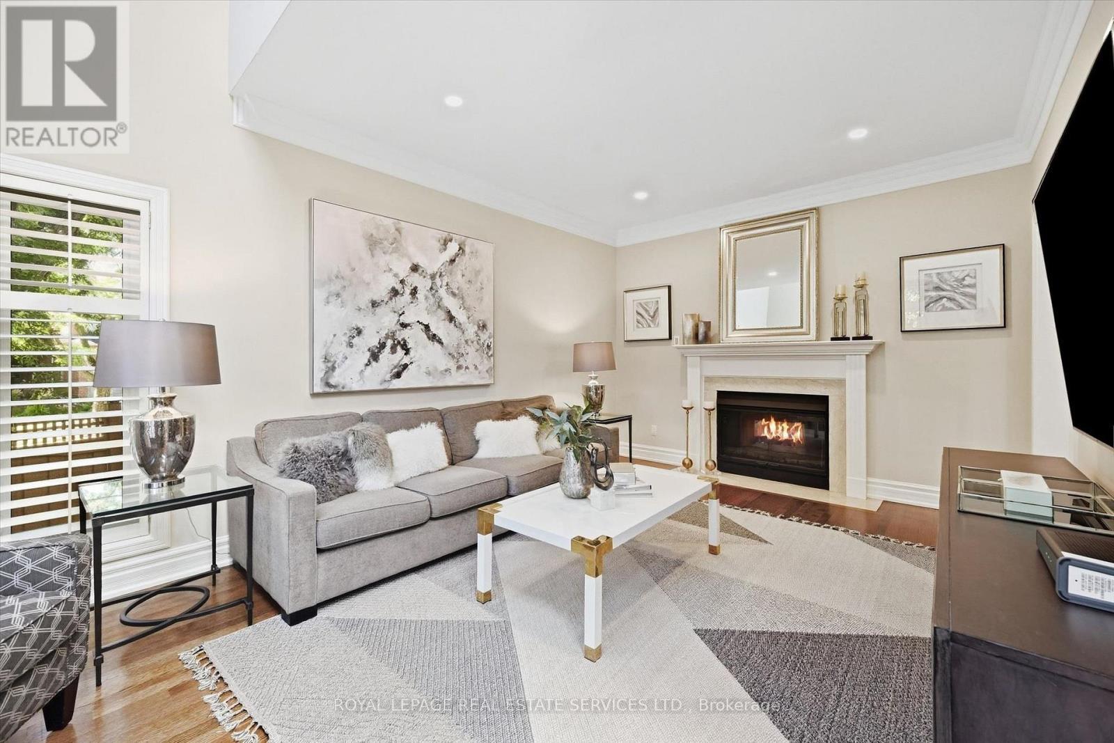 Family Room Features an Elegant Gas Fireplace - 340 Oakridge Court, Oakville, ON
