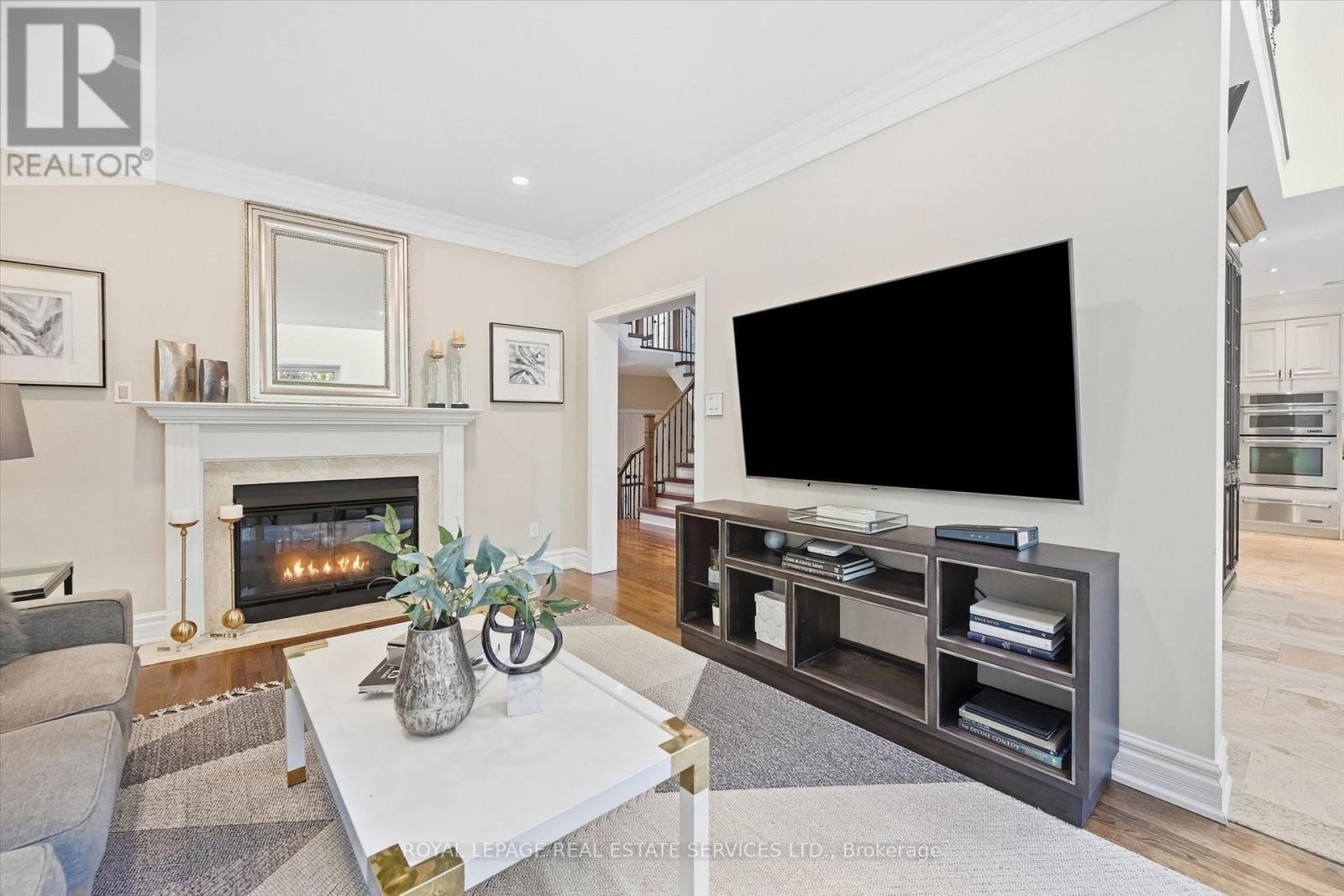 Family Room Features an Elegant Gas Fireplace - 340 Oakridge Court, Oakville, ON