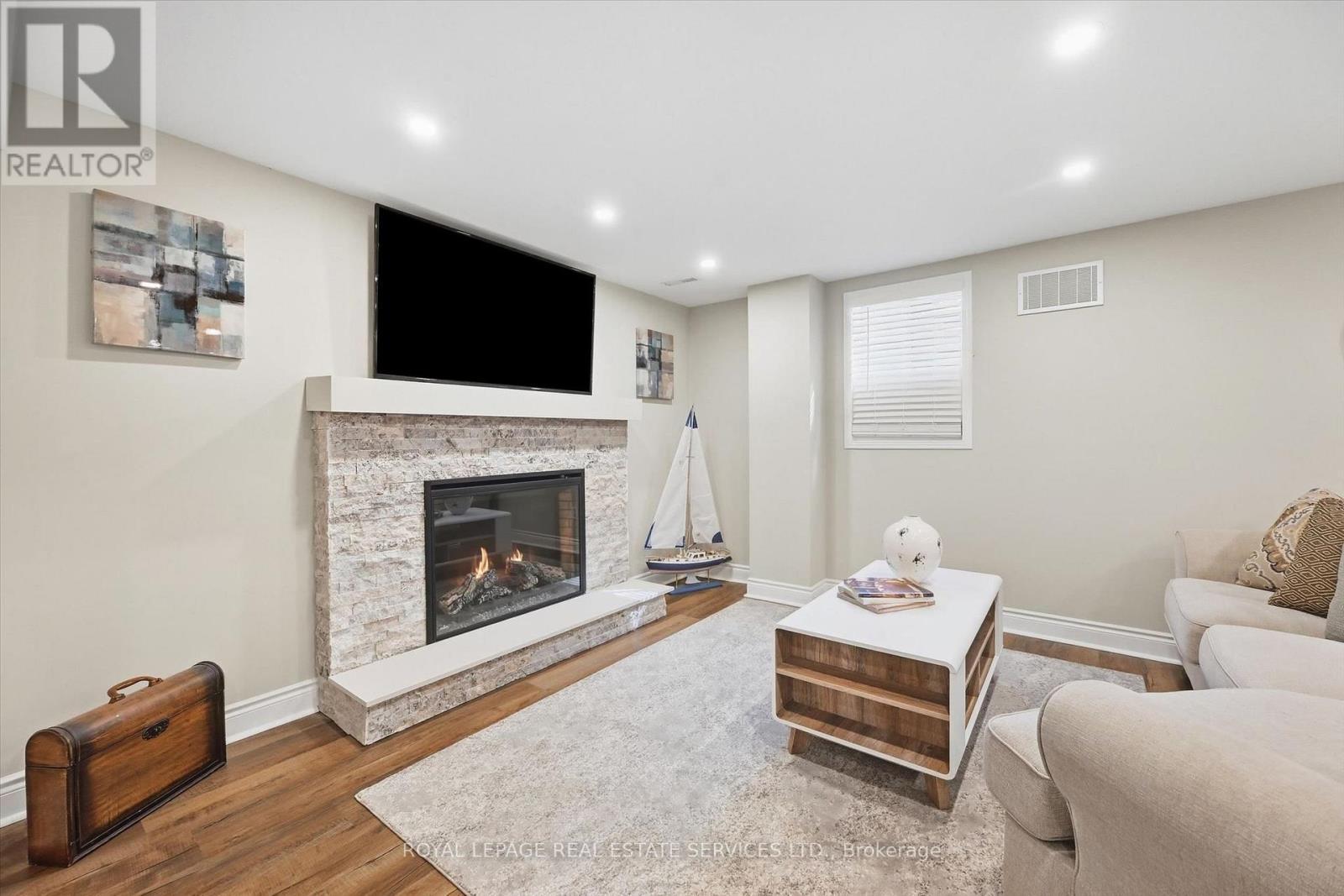 Large Recreation Room with an Electric Fireplace - 340 Oakridge Court, Oakville, ON