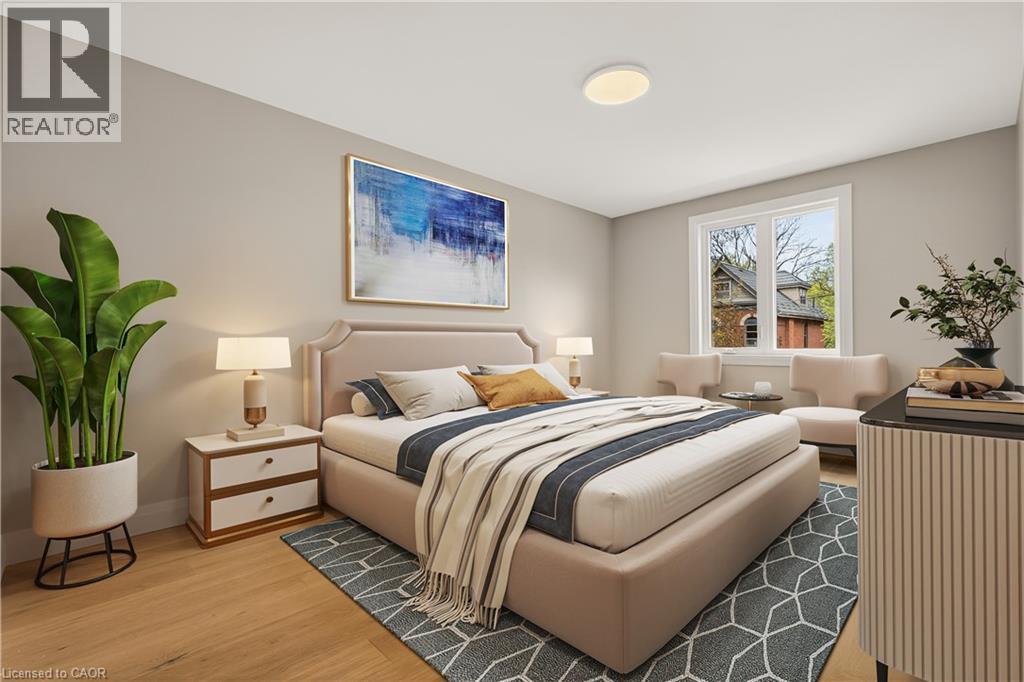 Recessed lighting, wood-finish flooring, and a large window with white trim - 279 Hess Street S, Hamilton, ON