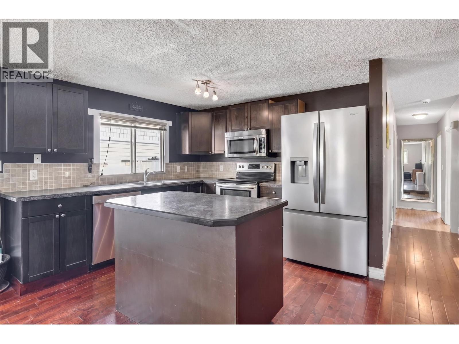 The kitchen has been virtually decluttered for presentation purposes. - 1311 25Th Avenue, Vernon, BC
