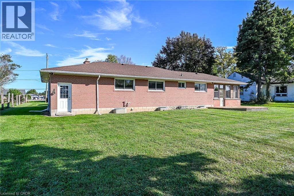 Brick exterior with a brown roof and a green lawn - 799 Highway 6, Caledonia, ON