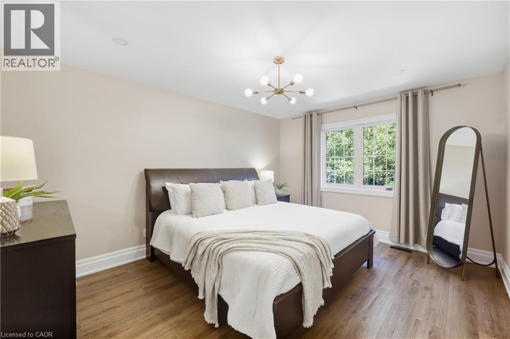 Wood-finish flooring, recessed ceiling lighting, single window, and a sputnik-style ceiling fixture - 2409 Postmaster Drive, Oakville, ON