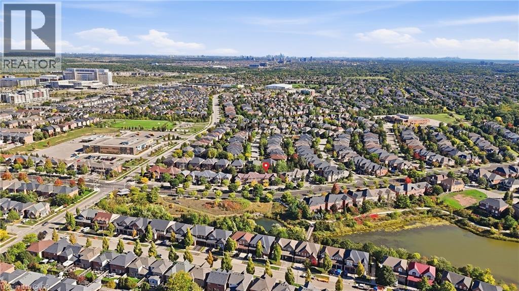 Aerial perspective highlighting residential properties, established green spaces, and a body of water - 2409 Postmaster Drive, Oakville, ON