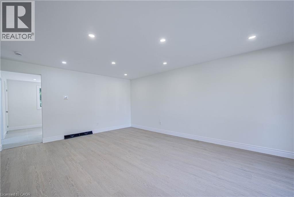 Recessed lighting, wood-finish flooring, white walls, and white trim - 210 Ferguson Avenue, Cambridge, ON