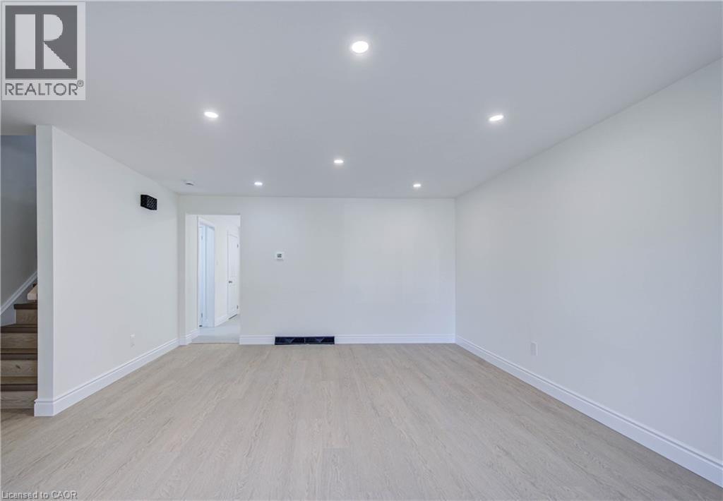 Recessed lighting, light wood-finish flooring, white walls, and bright white trim - 210 Ferguson Avenue, Cambridge, ON