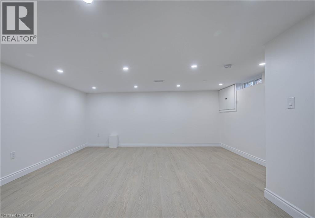Recessed ceiling lighting, light wood-finish flooring, white wall paint, and a window - 210 Ferguson Avenue, Cambridge, ON