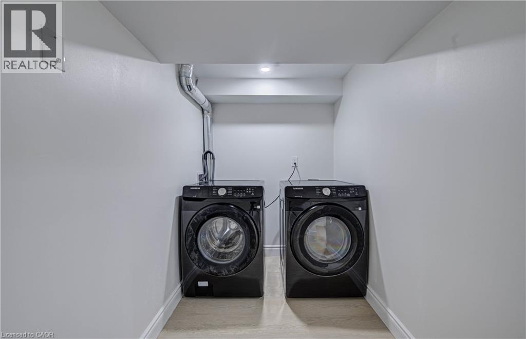 Dedicated laundry area featuring a built-in dryer vent, overhead lighting, and light-toned flooring - 210 Ferguson Avenue, Cambridge, ON