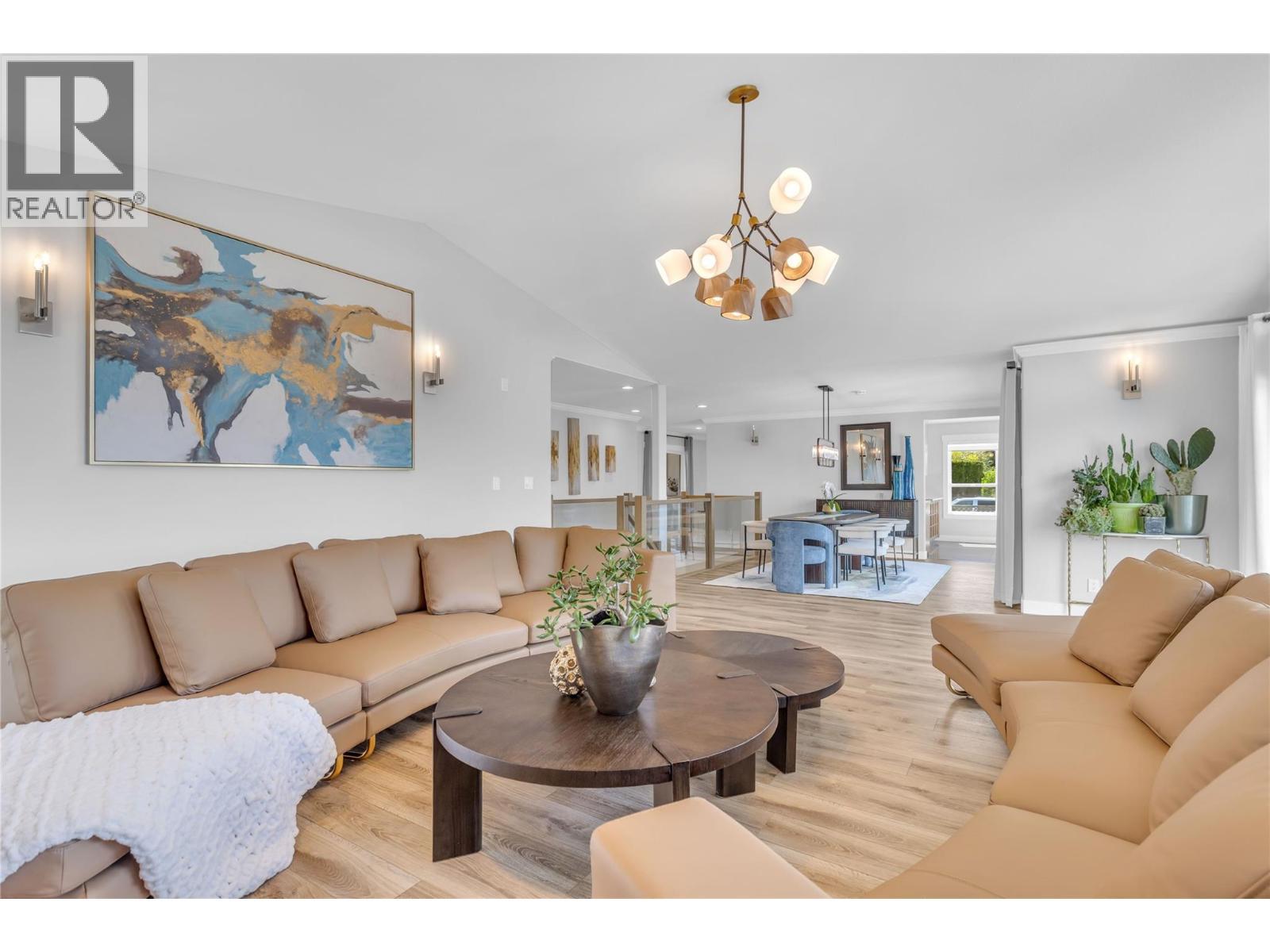 Party size living and dining room with vaulted ceiling and triple slide doors to the lake view deck - 4325 Takla Road, Kelowna, BC