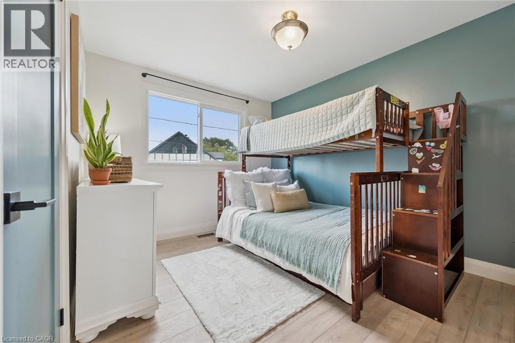 Light wood-finish flooring, white walls, a single window, and a ceiling-mounted light fixture - 8 Christian Street, Baden, ON