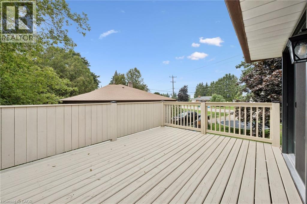 Expansive outdoor deck with wood flooring and a privacy fence - 8 Christian Street, Baden, ON