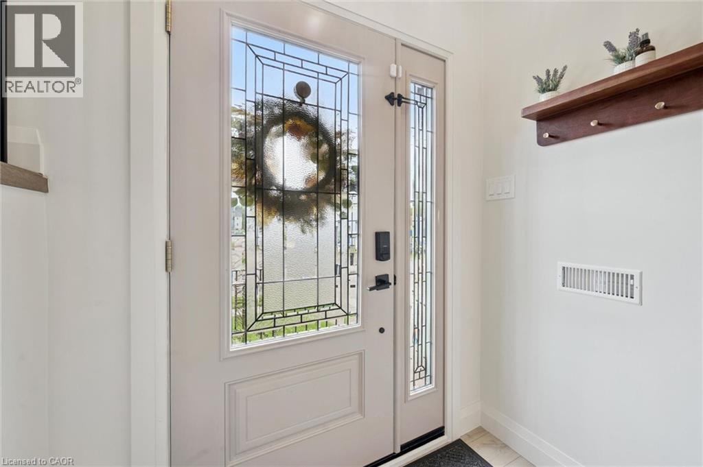 Entry door with decorative glass inserts and a sidelight panel - 8 Christian Street, Baden, ON