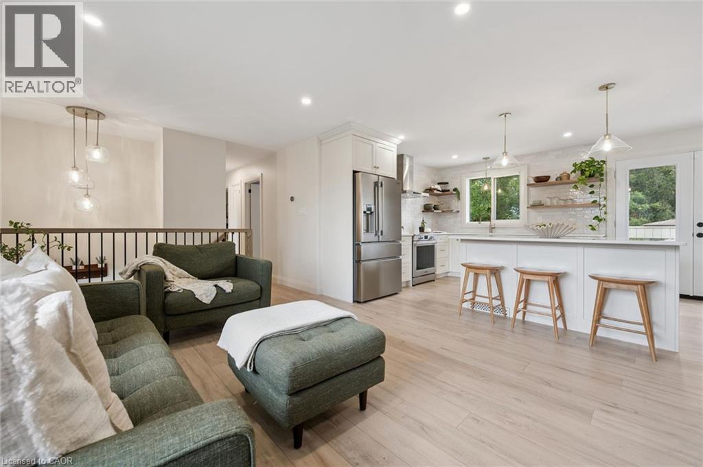 Recessed lighting, wood-finish flooring, white kitchen cabinetry, stainless steel appliances, and pendant lighting - 8 Christian Street, Baden, ON