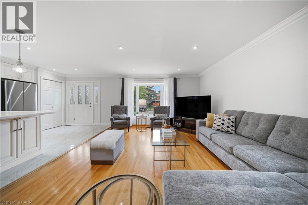 Open-concept living space featuring wood-finish flooring, recessed lighting, and crown molding - 6346 Neuchatel Road, Mississauga, ON