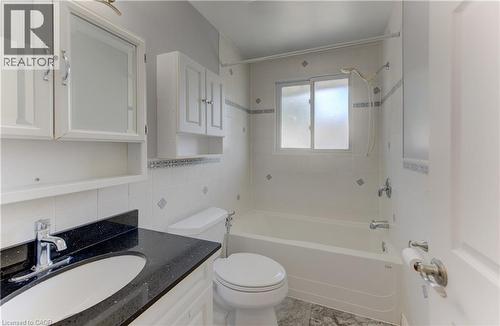 Integrated vanity with black speckled countertop and undermount sink - 64 Stanley Street, Cambridge, ON 