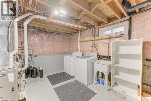 Utility area with exposed ceiling joists, a utility sink, and a high-level window - 64 Stanley Street, Cambridge, ON 