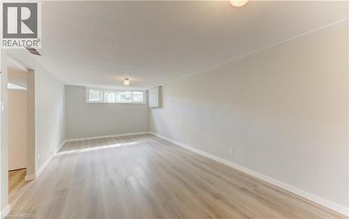 Recessed windows, light wood-finish flooring, and a flush mount light fixture - 64 Stanley Street, Cambridge, ON 