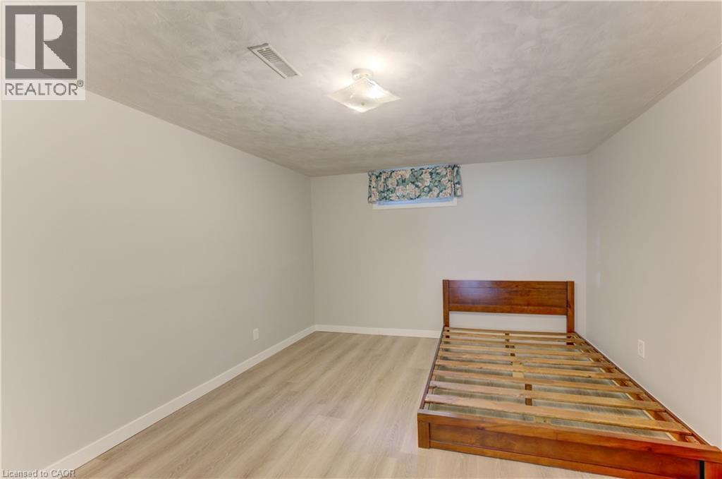 Light wood-finish flooring, neutral wall tones, and overhead flush-mount lighting - 64 Stanley Street, Cambridge, ON